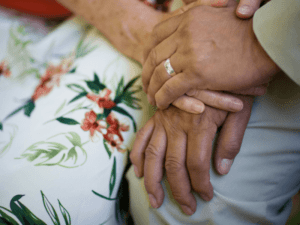 A close up shot of two people's hands holding each other